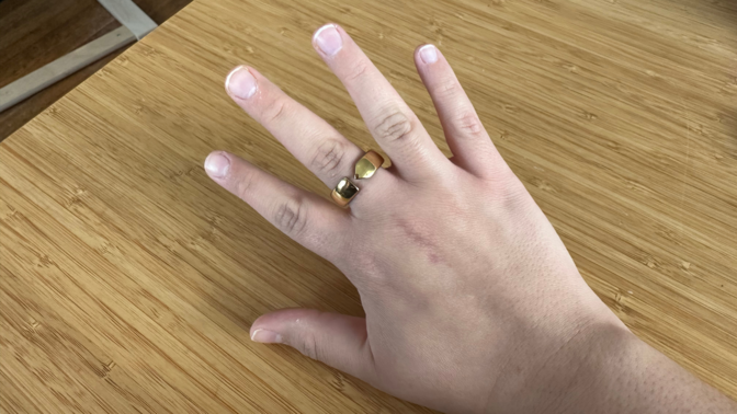 A hand wearing an Evie Ring